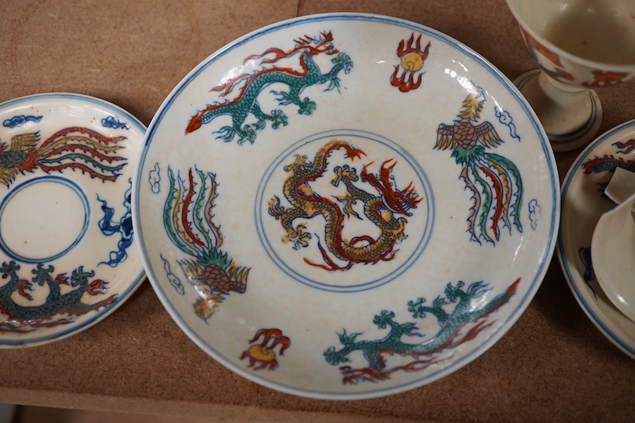 A pair of Chinese pedestal cups and three saucers. Condition - one cup severely damaged